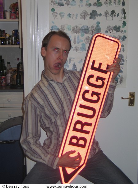 Andy Ojari air guitars on a Brugge road sign: York Street, Leicester, 13 June 2004