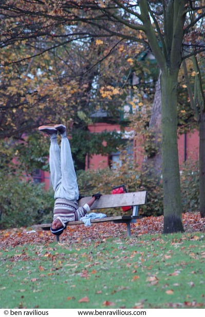 Man meditating upside down on a park bench: Spinney Hill Park, Leicester, 05 November 2004