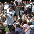 Man handing out leaflets at a peace rally, Victoria Park, Leicester, 16 July 2005
