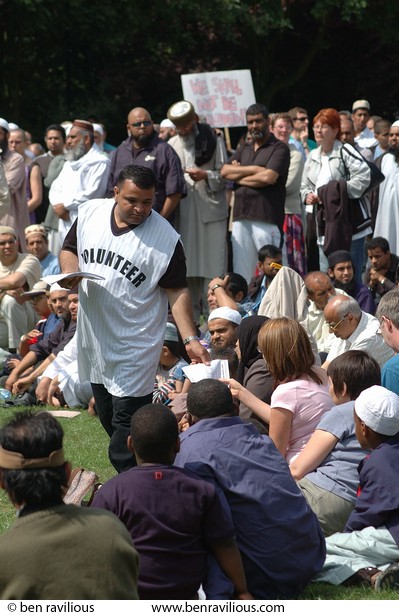 Man handing out leaflets at a peace rally: Victoria Park, Leicester, 16 July 2005