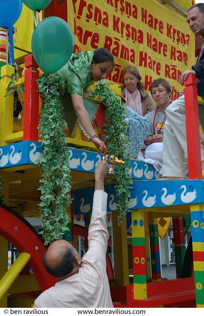Oil lamp being passed up to devotees on Ratha Yatra chariot: Humberstone Gate, Leicester, 31 July 2005