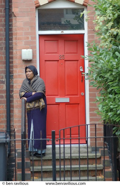 Woman watching carnival parade: Saxby Street, Leicester, 06 August 2005