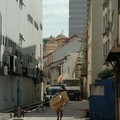 Man carrying cardboard boxes in a side street, Mackenzie Road, Singapore, 15 December 2005