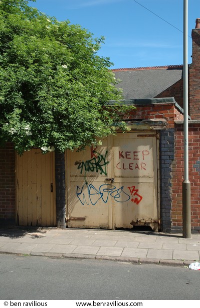 Back gate with graffiti and elder tree: Mere Road, Leicester, 03 June 2006