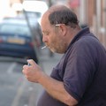 Lighting a cigarette, Baggrave Street, Spinney Hills, Leicester, 04 June 2006