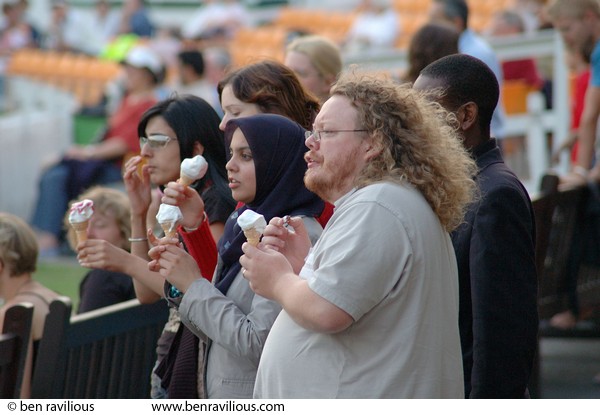 Spectators eating ice cream at an inter-faith cricket match: Imams vs Christian Clerics cricket match, Leicestershire Country Cricket Ground, Grace Road, Leicester, 11 September 2006